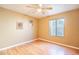 Cozy bedroom with laminate flooring, a ceiling fan, and a bright window at 750 S Cholla St, Gilbert, AZ 85233
