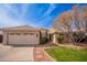 Charming single-story home features a tile roof, desert landscaping, and a two-car garage at 750 S Cholla St, Gilbert, AZ 85233