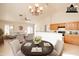 Bright living and dining area showcasing the open layout, chandelier and tile flooring at 750 S Cholla St, Gilbert, AZ 85233