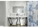 Bright bathroom with double sinks, decorative lights, and a vibrant shower curtain at 796 E Pepper Dr, Casa Grande, AZ 85122
