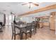 Bright open-concept dining area connected to the kitchen, featuring hardwood floors and a ceiling fan at 796 E Pepper Dr, Casa Grande, AZ 85122