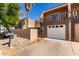 Charming townhome with an attached garage, desert landscaping, and a private balcony on a sunny day at 796 E Pepper Dr, Casa Grande, AZ 85122