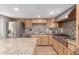 Modern kitchen with stainless steel appliances, granite countertops, and light wood cabinetry at 796 E Pepper Dr, Casa Grande, AZ 85122