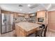 Spacious kitchen with stainless steel appliances, granite countertops, and custom wood cabinets at 796 E Pepper Dr, Casa Grande, AZ 85122