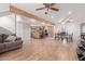 Open-concept living space with wood floors, exposed beam, a dining area, and a kitchen at 796 E Pepper Dr, Casa Grande, AZ 85122