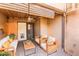 Inviting outdoor patio with comfortable wicker furniture, a ceiling fan, and shaded privacy screens at 796 E Pepper Dr, Casa Grande, AZ 85122