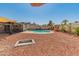 Beautiful backyard including a fenced pool, fire pit, and rock landscaping for outdoor enjoyment at 8540 N 104Th Ave, Peoria, AZ 85345