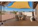 Backyard patio with shade sail over outdoor dining, exercise equipment and view to privacy fence at 8540 N 104Th Ave, Peoria, AZ 85345