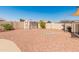 Expansive backyard with red rock landscaping, a storage shed, and a fire pit at 8540 N 104Th Ave, Peoria, AZ 85345