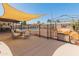 Inviting backyard with covered patio, shade sail, and fenced swimming pool, great for entertaining at 8540 N 104Th Ave, Peoria, AZ 85345