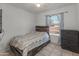 This bedroom features tile floors, white walls, and a comfortable bed at 8540 N 104Th Ave, Peoria, AZ 85345