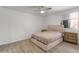 Neutral bedroom with a ceiling fan, and a comfortable bed at 8540 N 104Th Ave, Peoria, AZ 85345