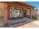 Inviting front porch featuring a seating area and decorative hanging planters at 8540 N 104Th Ave, Peoria, AZ 85345