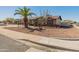 Single-story home with desert landscaping and palm tree, enhancing the property's curb appeal and charm at 8540 N 104Th Ave, Peoria, AZ 85345