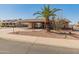 Charming single-story home featuring a well-maintained yard with a large palm tree and a covered front porch at 8540 N 104Th Ave, Peoria, AZ 85345