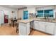 Bright kitchen with granite counters, white cabinets, stainless dishwasher and dining area at 8540 N 104Th Ave, Peoria, AZ 85345