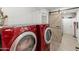This laundry room features a red washer and dryer and barn door to adjacent storage at 8540 N 104Th Ave, Peoria, AZ 85345