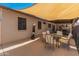 Spacious outdoor patio with a large shade, table, and punching bag, great for entertaining at 8540 N 104Th Ave, Peoria, AZ 85345