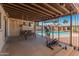Covered patio featuring workout equipment, a swing, and a view of the sparkling backyard pool at 8540 N 104Th Ave, Peoria, AZ 85345