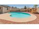 Backyard pool with a red rock surround, ideal for relaxation and enjoying outdoor living at 8540 N 104Th Ave, Peoria, AZ 85345