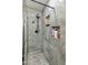 Walk-in shower featuring gray marble-look tile with built-in niches for toiletries at 8540 N 104Th Ave, Peoria, AZ 85345
