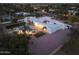 A captivating property featuring a pool and manicured lawn illuminated by outdoor lighting at 9900 N 52Nd St, Paradise Valley, AZ 85253