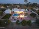 Night aerial view of a luxurious home with an inviting pool and landscape lighting at 9900 N 52Nd St, Paradise Valley, AZ 85253