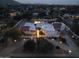 Charming home with a beautiful yard and inviting entrance lit up at twilight at 9900 N 52Nd St, Paradise Valley, AZ 85253
