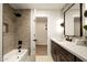 Bathroom with a soaking tub, dark hardware, and an opening to another room at 9900 N 52Nd St, Paradise Valley, AZ 85253