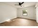 Minimalist bedroom featuring wood-look tile flooring, a window, and a ceiling fan at 9900 N 52Nd St, Paradise Valley, AZ 85253