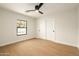 Bright bedroom with hardwood floors, ceiling fan, and a window providing ample natural light at 9900 N 52Nd St, Paradise Valley, AZ 85253