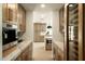 Stylish butler's pantry area with built-in coffee machine, marble countertops, and custom cabinetry at 9900 N 52Nd St, Paradise Valley, AZ 85253