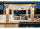 Charming poolside cabana with tile roof, ceiling fan, and comfortable seating area at 9900 N 52Nd St, Paradise Valley, AZ 85253