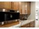 Close up of the butler's pantry coffee bar with stone countertops and custom cabinets at 9900 N 52Nd St, Paradise Valley, AZ 85253