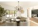 Bright dining room features a chandelier, round table, and large windows at 9900 N 52Nd St, Paradise Valley, AZ 85253