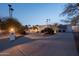 Long driveway leading to an estate home, showcasing professional landscaping and exterior lighting at 9900 N 52Nd St, Paradise Valley, AZ 85253