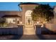 Charming exterior with a tile roof, arched entryway, and manicured landscaping at 9900 N 52Nd St, Paradise Valley, AZ 85253