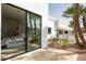 An exterior view from the patio into the main bedroom, highlighting access to the pool at 9900 N 52Nd St, Paradise Valley, AZ 85253