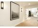Bright hallway featuring modern light fixtures, artwork, and wood flooring at 9900 N 52Nd St, Paradise Valley, AZ 85253