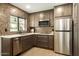 Updated kitchen featuring stainless steel appliances, mosaic backsplash and tile flooring at 9900 N 52Nd St, Paradise Valley, AZ 85253
