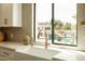 Kitchen sink boasts a backyard view of the pool, gazebo, and travertine tile at 9900 N 52Nd St, Paradise Valley, AZ 85253