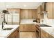 Modern kitchen with stainless steel appliances, marble countertops, and natural wood cabinets at 9900 N 52Nd St, Paradise Valley, AZ 85253