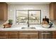 Kitchen sink with stainless steel sink and a view of the backyard and outdoor living space at 9900 N 52Nd St, Paradise Valley, AZ 85253