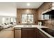 Modern kitchen showcasing stainless steel appliances, mosaic backsplash, and an open view to the living area at 9900 N 52Nd St, Paradise Valley, AZ 85253