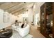 Open living room with wood floors, vaulted ceilings, and a view into the office and main bedroom at 9900 N 52Nd St, Paradise Valley, AZ 85253