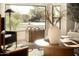 Sunlit living room with modern decor, a coffee table, and large windows at 9900 N 52Nd St, Paradise Valley, AZ 85253
