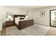 Spacious main bedroom featuring a cozy bed, neutral tones, and sliding glass doors to the outside at 9900 N 52Nd St, Paradise Valley, AZ 85253