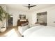 Spacious main bedroom with wood floors, a large plant, and seating in front of the fireplace at 9900 N 52Nd St, Paradise Valley, AZ 85253