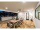 Charming covered outdoor dining area with a long table, comfortable seating, and an outdoor kitchen nearby at 9900 N 52Nd St, Paradise Valley, AZ 85253