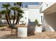Stylish outdoor kitchen area featuring a built-in grill, bar seating, and sleek white architecture at 9900 N 52Nd St, Paradise Valley, AZ 85253